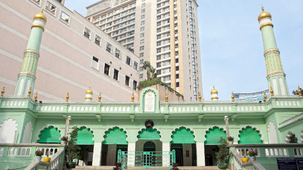 Saigon Central Mosque, with its signature turquoise dome, stands out as a serene architectural gem amidst the bustling neighborhood 